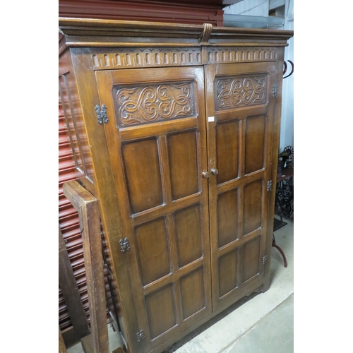 2115 - A carved oak two door wardrobe   (R) £40