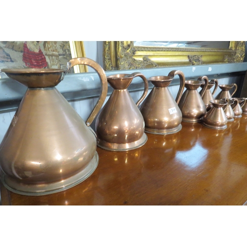 2141 - A set of ten graduating copper jugs   (R) £100