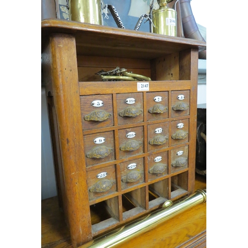 2147 - A 19th Century oak bank of 12 small drawers with cup and enamel numbers   (C)