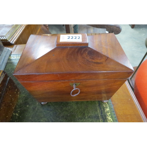 2222 - A Georgian flame mahogany scarcophagus shaped tea caddy with wooden ring handles and key            ... 