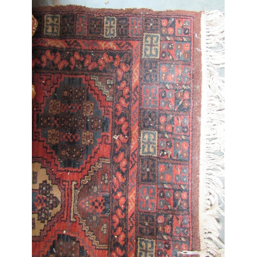 2446 - A red pattern rug    (E)  £15-20