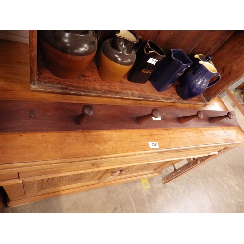 2426 - A teak peg coat rack