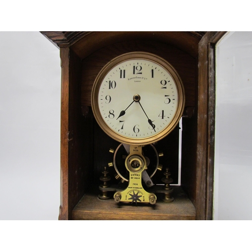 7766 - An early 20th Century oak cased Eureka clock with early electric movement and large balance wheel, A... 