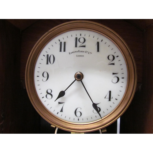 7766 - An early 20th Century oak cased Eureka clock with early electric movement and large balance wheel, A... 