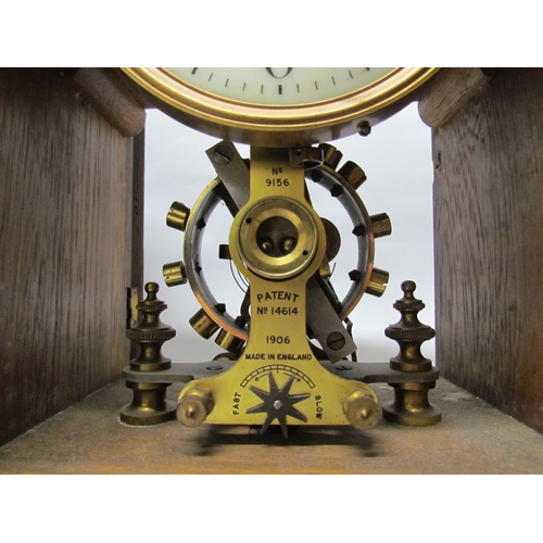 7766 - An early 20th Century oak cased Eureka clock with early electric movement and large balance wheel, A... 