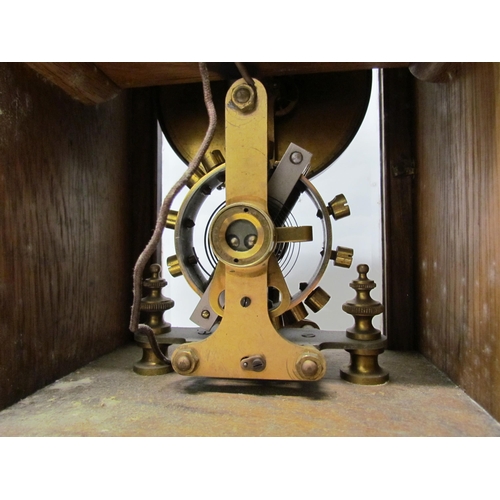 7766 - An early 20th Century oak cased Eureka clock with early electric movement and large balance wheel, A... 