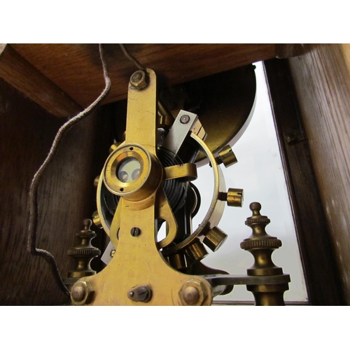 7766 - An early 20th Century oak cased Eureka clock with early electric movement and large balance wheel, A... 