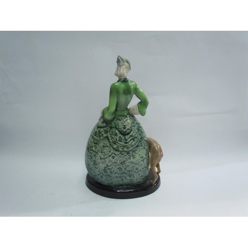 7780 - A Goldscheider figure of maiden in a green dress with hound, 35cm tall, marks to base, made in Germa... 