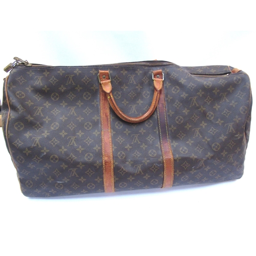 7846 - LOUIS VUITTON; Keepall 60 Boston travel bag. Brown monogram. The leather handles, banding and piping... 