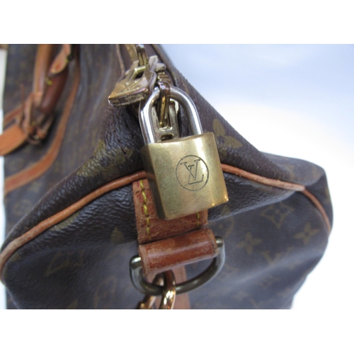 7846 - LOUIS VUITTON; Keepall 60 Boston travel bag. Brown monogram. The leather handles, banding and piping... 