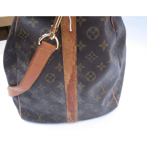 7846 - LOUIS VUITTON; Keepall 60 Boston travel bag. Brown monogram. The leather handles, banding and piping... 