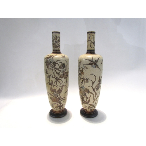 7446 - A pair of Martin Brothers stoneware vases of tall slender form, incised with birds and insects in fl... 