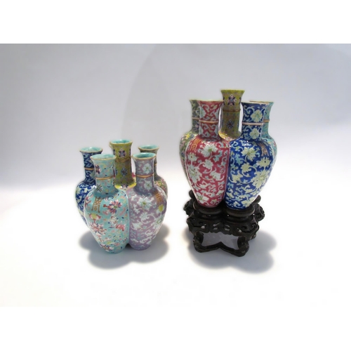 7448 - A pair of Oriental tulip vases in multicolour ground and foliate decoration, marks to base