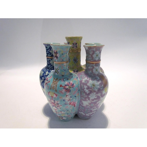 7448 - A pair of Oriental tulip vases in multicolour ground and foliate decoration, marks to base