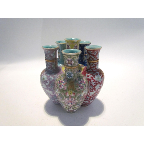 7448 - A pair of Oriental tulip vases in multicolour ground and foliate decoration, marks to base