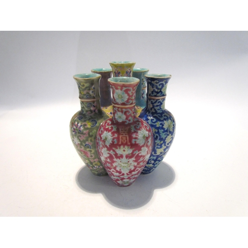 7448 - A pair of Oriental tulip vases in multicolour ground and foliate decoration, marks to base