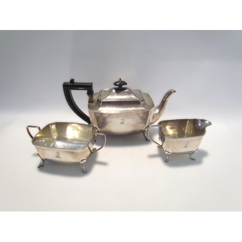 7450 - An Aaron Lufkin Dennison silver three piece tea set with crested detail, Birmingham 1932, 993g  (R) ... 