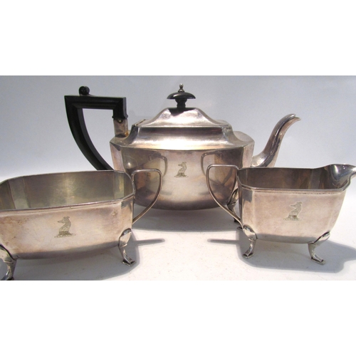 7450 - An Aaron Lufkin Dennison silver three piece tea set with crested detail, Birmingham 1932, 993g  (R) ... 