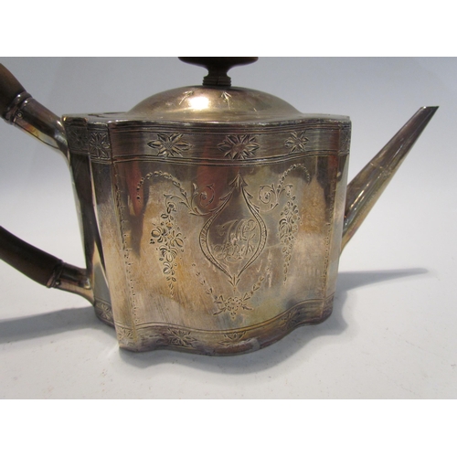 7453 - A George III silver teapot of serpentine form with monogrammed cartouche, floral swag detail, treen ... 