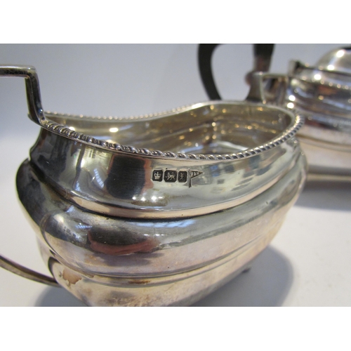 7457 - A Walker & Hall silver three piece tea set, gadrooned edge, presentation engraving dating to 1916, S... 