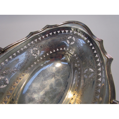 7461 - A Charles Stuart Harris silver basket, swing handle, with pierced borders and engraved swag design, ... 