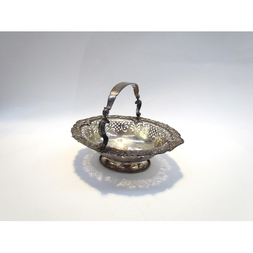 7468 - A CH and Co silver pierced basket with overhead handle, London 1937, 542g