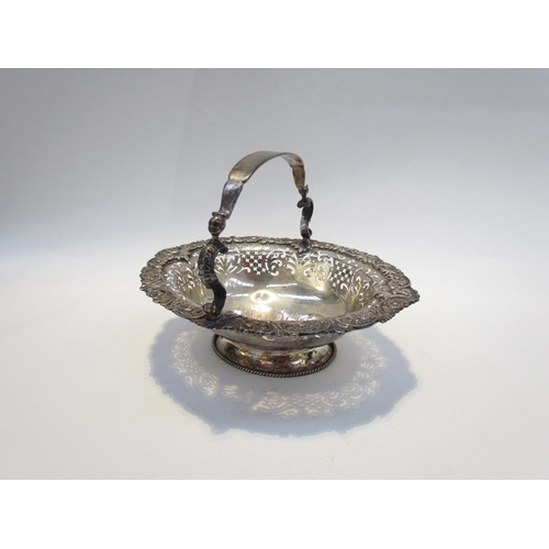 7468 - A CH and Co silver pierced basket with overhead handle, London 1937, 542g