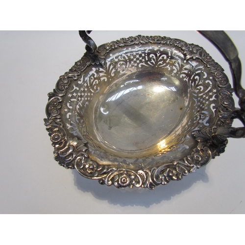 7468 - A CH and Co silver pierced basket with overhead handle, London 1937, 542g