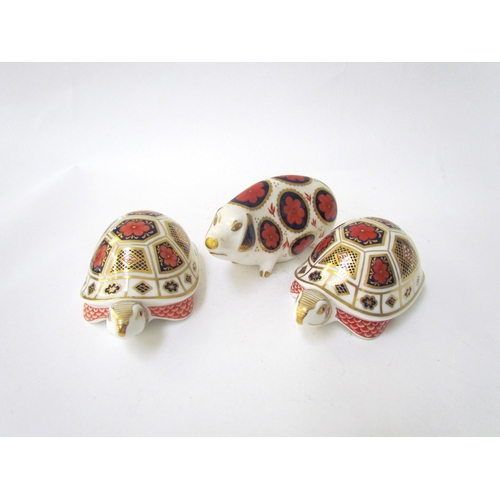 7499 - A pair of Royal Crown Derby paperweights as Tortoises, gold stoppers and a Royal Crown Derby paperwe... 