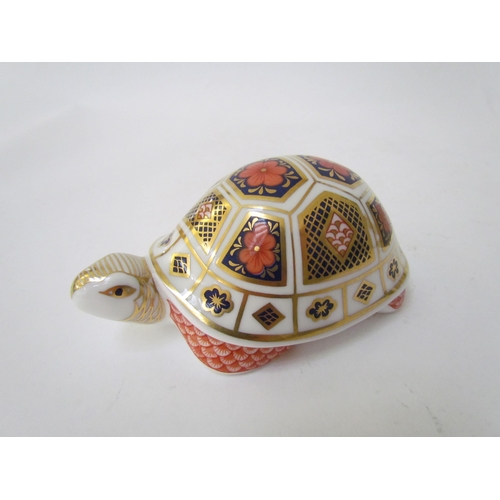 7499 - A pair of Royal Crown Derby paperweights as Tortoises, gold stoppers and a Royal Crown Derby paperwe... 