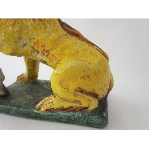 7518 - A 19th Century Italian faience figure of a lion with heraldic crest, 23cm high