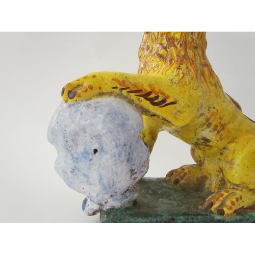 7518 - A 19th Century Italian faience figure of a lion with heraldic crest, 23cm high