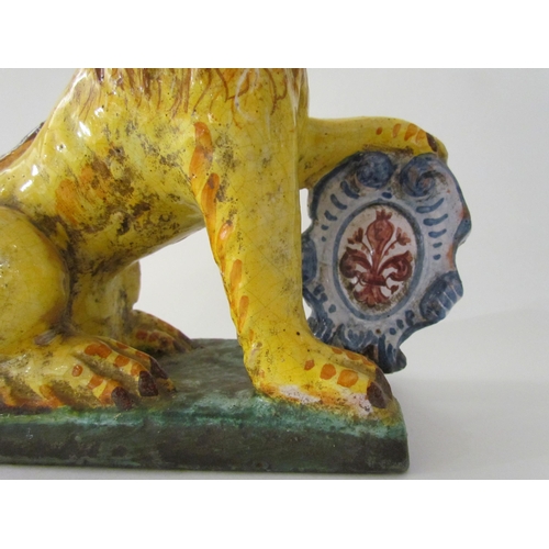 7518 - A 19th Century Italian faience figure of a lion with heraldic crest, 23cm high