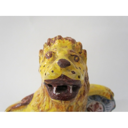 7518 - A 19th Century Italian faience figure of a lion with heraldic crest, 23cm high