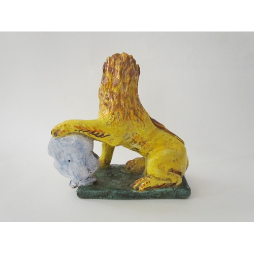 7518 - A 19th Century Italian faience figure of a lion with heraldic crest, 23cm high