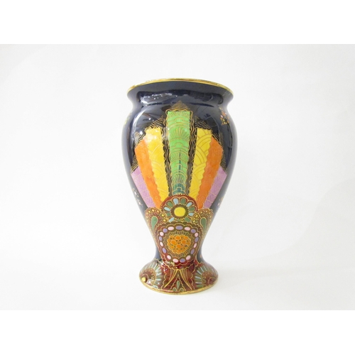 7519 - A Carlton Ware lustre vase with Art Deco styling, blue ground with multicoloured patterns, enriched ... 