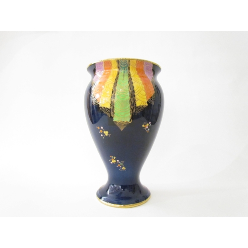 7519 - A Carlton Ware lustre vase with Art Deco styling, blue ground with multicoloured patterns, enriched ... 