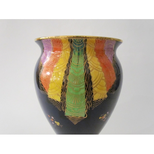 7519 - A Carlton Ware lustre vase with Art Deco styling, blue ground with multicoloured patterns, enriched ... 