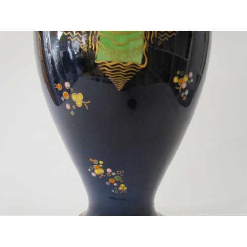 7519 - A Carlton Ware lustre vase with Art Deco styling, blue ground with multicoloured patterns, enriched ... 