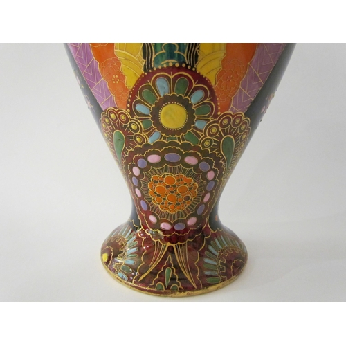 7519 - A Carlton Ware lustre vase with Art Deco styling, blue ground with multicoloured patterns, enriched ... 