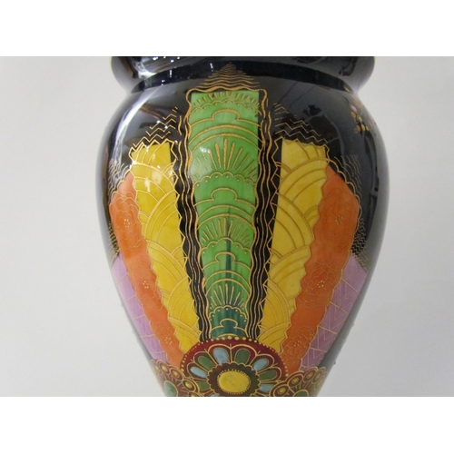 7519 - A Carlton Ware lustre vase with Art Deco styling, blue ground with multicoloured patterns, enriched ... 