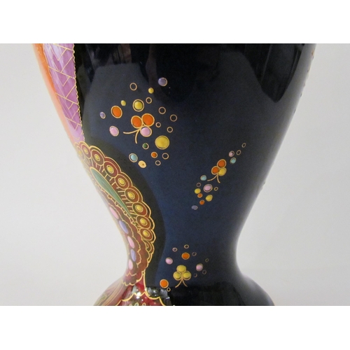 7519 - A Carlton Ware lustre vase with Art Deco styling, blue ground with multicoloured patterns, enriched ... 