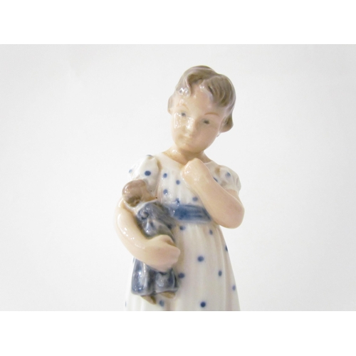 7521 - A Royal Copenhagen figure of child holding a doll, 15cm tall