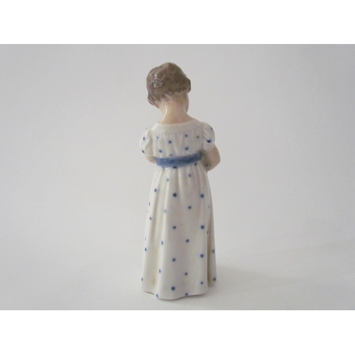 7521 - A Royal Copenhagen figure of child holding a doll, 15cm tall