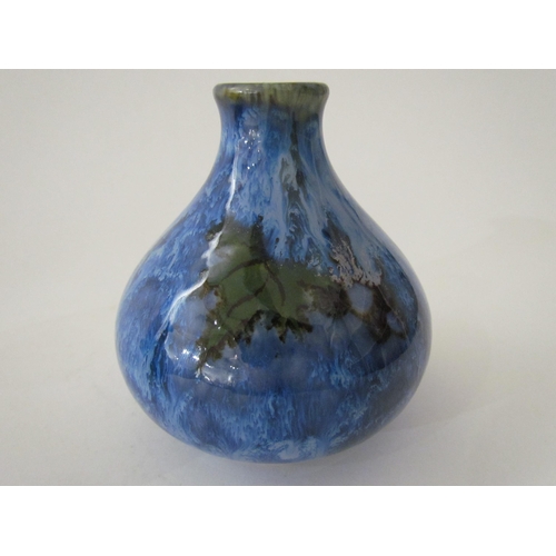 7524 - A Cobridge Stoneware onion shaped vase in mottled blue glaze with bunches of grapes and vine leaf de... 