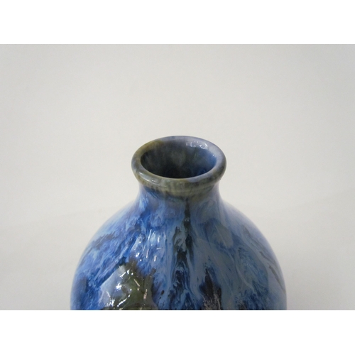 7524 - A Cobridge Stoneware onion shaped vase in mottled blue glaze with bunches of grapes and vine leaf de... 