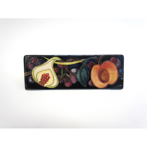 7546 - A Moorcroft Pottery Advertising stand in Queen's Choice pattern, 18cm length  (R)  £150 COLLECTED