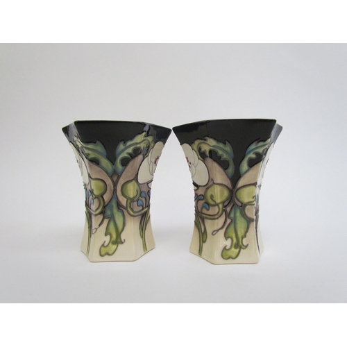 7555 - A pair of Moorcroft Au Lait pattern coffee cups and saucers