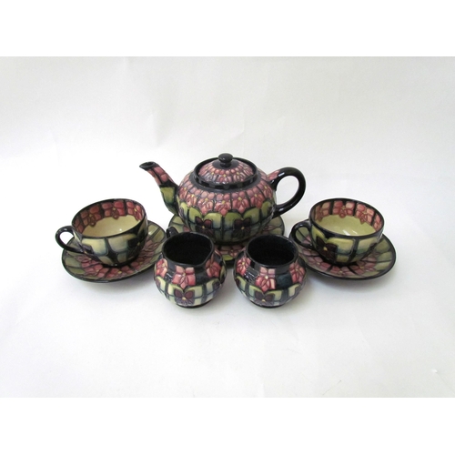 7556 - A Moorcroft Violet pattern tea service for two