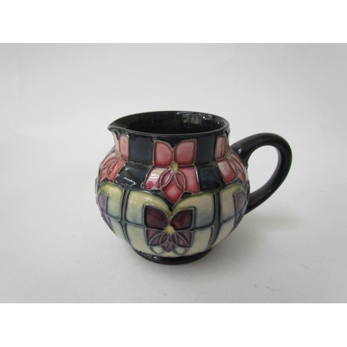 7556 - A Moorcroft Violet pattern tea service for two